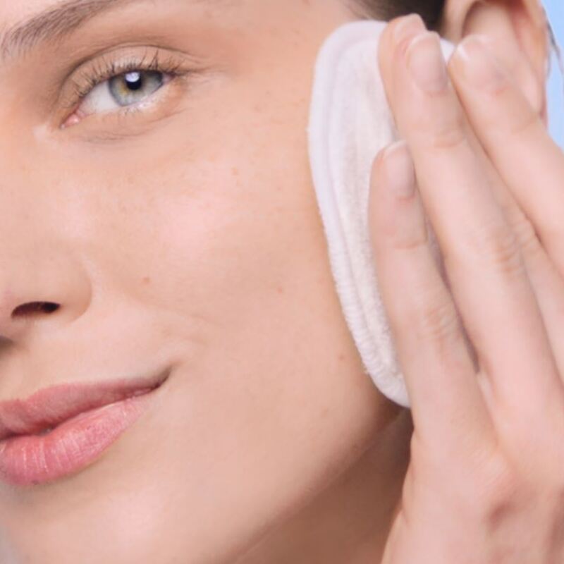 Woman cleaning her skin with micellar water